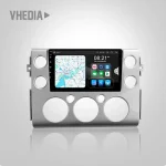 Infotainment head unit embedded in a silver dashboard frame, showing a navigation map and app icons on a touchscreen panel (VHE DIA branding).