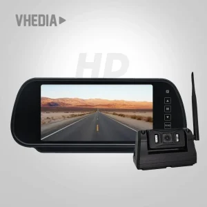 Dash cam and mirror-style display in a car showing a straight desert highway on the screen, with a connected camera unit nearby.