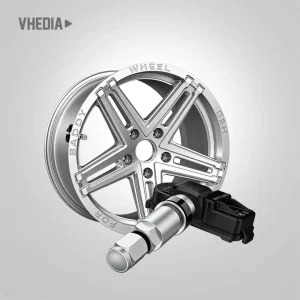 TPMS 6 - VHEDIA Close-up of a shiny five-spoke alloy car wheel with a valve stem and a TPMS sensor attached to the hub area.