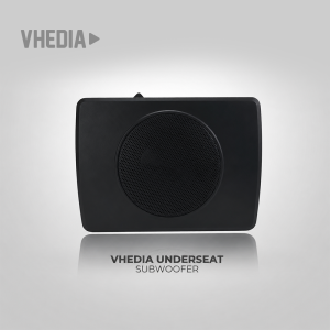 VHEDIA underseat subwoofer: black rectangular enclosure with a round perforated speaker grille on display, gray gradient background.