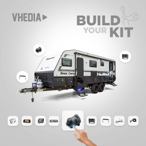Interactive visualization of a travel trailer with circular accessory icons around it, and a hand selecting the central kit component at the bottom. The page title reads Build Your Kit.