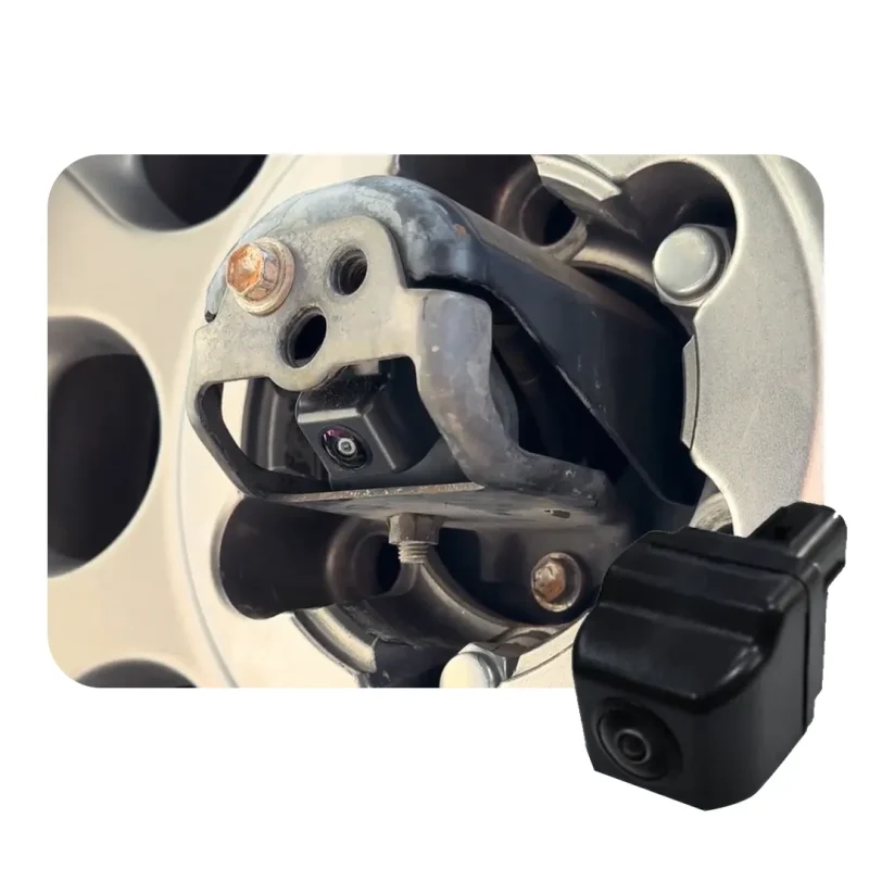 Small black action camera mounted on a metal bracket attached near a car wheel hub for exterior recording.