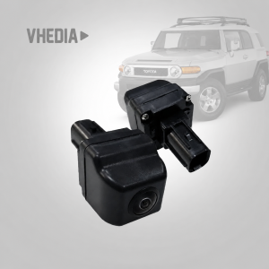 Close-up of a black backup camera module for a vehicle, with a blurred SUV in the background to suggest installation context.