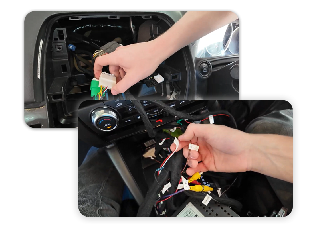Person working with a car's wiring harness under the dashboard, connecting white and green connectors and exposed wires in a dim interior panel area.